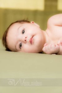 bambina neonata sveglia su sfondo verde